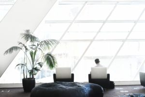 Man sitting in front of a window alone