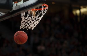 A basketball coming out of a basketball net