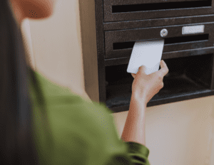 Woman putting mail in mailbox