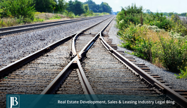 Railroad tracks converging along a rail corridor, illustrating rail takings and eminent domain issues for Florida property owners along the I-4 corridor.