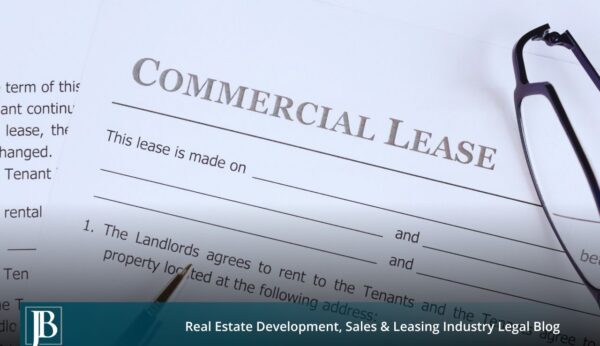 Signed Florida commercial lease agreement with reading glasses and pen, illustrating commercial lease disputes between landlords and tenants.