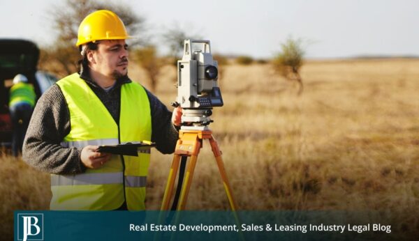 Land surveyor with a total station measuring a Florida field, illustrating the property valuation issues an Eminent Domain Attorney in Florida helps landowners navigate before accepting a condemnation offer.