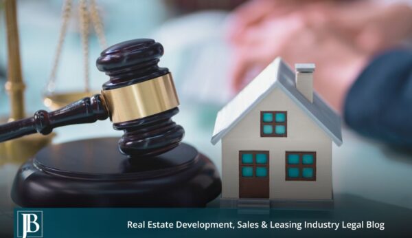 Florida eminent domain lawyer concept image showing a judge's gavel beside a model house, representing property takings and just compensation cases.