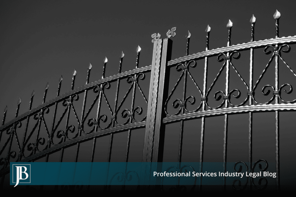Closed ornate black wrought iron gate photographed against a gray sky, symbolizing the legal gatekeeping standards Florida businesses use to defend fraud claims in commercial disputes.