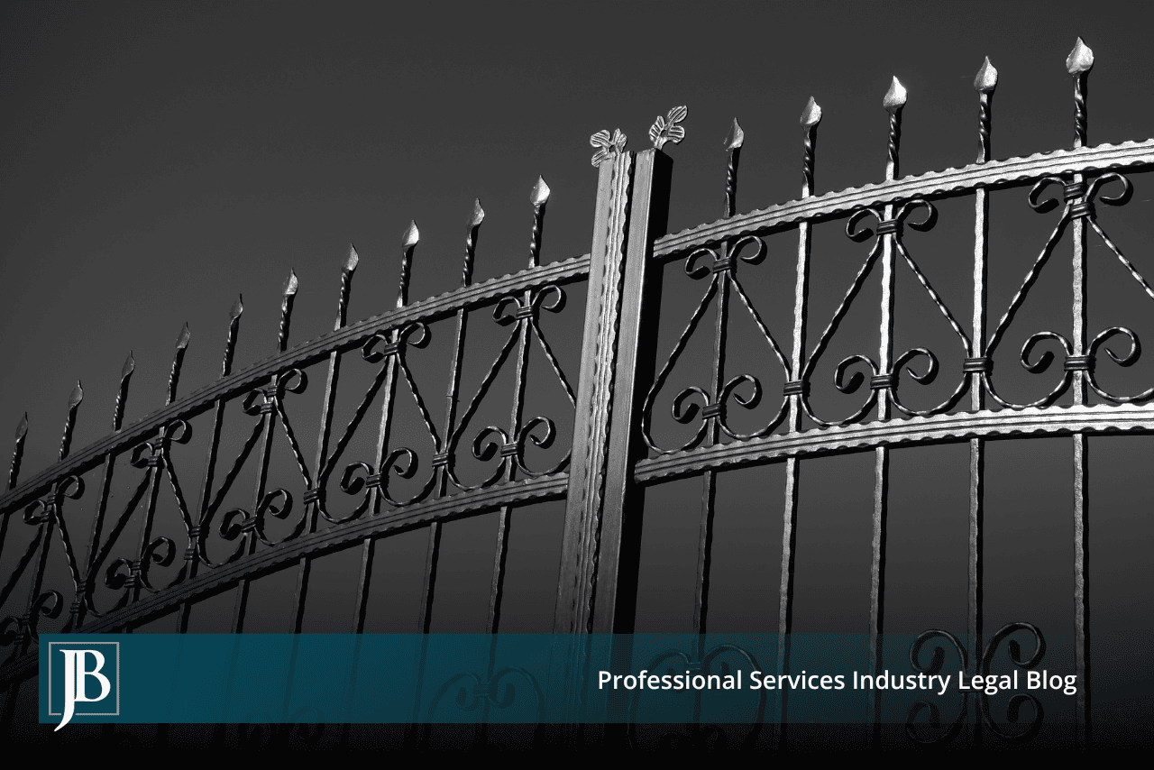 Closed ornate black wrought iron gate photographed against a gray sky, symbolizing the legal gatekeeping standards Florida businesses use to defend fraud claims in commercial disputes.