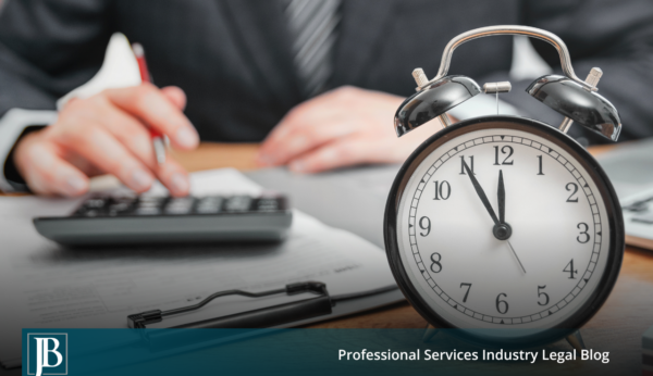 Business professional at a desk with a calculator and paperwork beside an alarm clock, illustrating the timing pressure businesses face when weighing early settlement in consumer class actions.