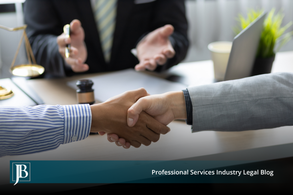 Two business professionals shaking hands across a desk with a gavel and scales of justice nearby, illustrating settlement of a Florida business dispute outside of court.