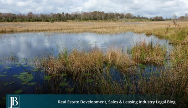 SJRWMD Acquisitions in the Black Creek Watershed: A Landowner's Primer If you own property in or near the Black Creek watershed in Clay County, you may have already heard from the St. Johns River Water Management District (SJRWMD), or you may be bracing for a letter, a phone call, or a knock on the door. The District has spent years building water resource projects in southwest Clay County, and its interest in land across the region is not slowing down. Here is the good news for property owners: a water management district's power over your land is far more limited than most people assume. Understanding those limits is the difference between accepting a first offer and negotiating from a position of strength. This primer walks through what the District can and cannot do, how its acquisition process works, and the rights that protect you at every step. What Is the Black Creek Project, and Why Is SJRWMD Buying Land There? The Black Creek watershed sits in southwest Clay County, and it has become central to northeast Florida's long-term water supply strategy. To understand why the District wants land here, it helps to understand what it is building. The Black Creek Water Resource Development Project at a Glance The Black Creek Water Resource Development Project is designed to capture up to 10 million gallons per day of flow from the Black Creek South Fork when water levels are high enough, then pump that water through a transmission system toward the Keystone Heights area, where it recharges the Upper Floridan aquifer near Alligator Creek. The estimated $41 million project runs through southwest Clay County between Penney Farms and Camp Blanding, and part of its funding comes from the Land Acquisition Trust Fund created by Amendment 1, the Florida Land and Conservation Initiative. A project like this needs a corridor of land and easements to run pipe, build recharge infrastructure, and protect the surrounding water resources. That is where private landowners enter the picture. Why the District Needs Private Land SJRWMD is an 18-county agency headquartered in Palatka, and its core reason for buying land is to protect water resources. According to the District's own land acquisition program, it targets priority lands such as floodplains, sensitive wetlands, and groundwater recharge areas. The Black Creek watershed checks every one of those boxes, which is why owners in the area are seeing acquisition activity. If you are evaluating what a sale or easement means for a larger holding, our team's work on complex real property improvement issues is a useful starting point. Can SJRWMD Take My Land by Eminent Domain? This is the question that keeps landowners up at night, and the answer is more reassuring than you might expect. The Limited Condemnation Power of Water Management Districts Florida law grants water management districts broad authority to acquire land by purchase, gift, lease, or eminent domain. But there is a crucial catch written directly into the statute. Under Florida Statute Section 373.139, the District's "eminent domain powers may be used only for acquiring real property for flood control and water storage or for curing title defects or encumbrances to real property owned by the district or to be acquired by the district from a willing seller." Read that again, because it is the single most important sentence for any landowner in the Black Creek watershed. The District cannot simply condemn your property for general conservation, aquifer recharge, or water supply development. Its forced-taking power is restricted to flood control and water storage, plus narrow title-clearing situations. For most other purposes, the District has to find a willing seller. Whether a specific project component qualifies as "flood control and water storage" is a legal question that turns on the facts, and it is exactly the kind of issue where experienced eminent domain and condemnation counsel earns its keep. Do not assume the District's characterization of its own project is the final word. What "Willing Seller" Really Means The phrase "willing seller" is your leverage. If the District wants your land for a purpose outside its condemnation authority, it needs your agreement to sell. That means you set terms, you can say no, and you can negotiate price, scope, and conditions. It also means the District often invites landowners to come to it. The District accepts applications from owners who want their property considered for purchase, and every restriction, term, and condition of a purchase is negotiable. Being a willing seller does not mean being a passive one. How SJRWMD Acquisition Works, Step by Step Water management district acquisitions follow a structured process. Knowing the sequence helps you spot where you have input and where deadlines matter. The Five-Year Work Plan and Public Notice The District adopts a five-year land acquisition work plan, and it can only do so after a public hearing. It must give at least 14 days' advance notice of that hearing and separately notify the county commission where a proposed project sits. If your property appears in a work plan, that public process is your early warning and your chance to be heard before anything is final. Owners who want to track how a project might affect zoning or development potential should also review land use and zoning considerations. Appraisals and the Confidentiality Window Value drives everything in an acquisition. Under Section 373.139, the District must obtain at least one appraisal for each parcel, and two appraisals are required when the estimated value exceeds $1 million. Those appraisal reports, offers, and counteroffers stay confidential until an option contract is signed or until 30 days before the governing board considers a purchase. That confidentiality window cuts both ways. It can keep you in the dark about the District's number, so getting your own independent appraisal early is one of the smartest moves a landowner can make. A sound valuation record also helps if you ever face a related boundary line or quiet title dispute that affects what you actually own. Fee Simple vs. Less-Than-Fee Acquisition Not every deal means giving up your land entirely. Since 1996, Florida law has encouraged districts to use "less-than-fee" alternatives instead of buying the full ownership package. In practice, that usually means an easement or a set of use restrictions rather than an outright sale. The trade-offs matter: Fee simple means the District buys the complete bundle of ownership rights, and you no longer own the land. Less-than-fee means you keep title, keep the property on the tax rolls, and continue using and managing the land, subject to negotiated conservation restrictions. Because an easement can quietly reshape how you use a property for generations, the specific language deserves close review. Our guidance on easements and restrictive covenants explains why a single clause can matter more than the price. What Are Your Rights and Protections as a Landowner? Whether the District is negotiating a voluntary purchase or pursuing a lawful condemnation, Florida law gives owners strong protections. The Constitutional Right to Full Compensation Florida's Constitution does not just require "just" compensation like the federal standard. Under Article X, Section 6 of the Florida Constitution, no private property can be taken except for a public purpose and with full compensation paid to the owner. Florida courts have long treated this "full compensation" language as one of the most owner-friendly property protections in the country. What Full Compensation Can Include Full compensation is not always limited to the raw value of the dirt being taken. Depending on the facts, it can include damages to the portion of your property that remains after a partial taking, often called severance damages, along with other losses the taking causes. If a pipeline corridor or recharge structure splits a parcel or cuts off access, the impact on what is left can be a significant part of the claim. Owners of income-producing property, including retail, office, industrial, and multi-residential holdings, should pay particular attention to business and rental impacts. Attorney's Fees and Costs Here is another protection unique to Florida eminent domain practice. Under Chapter 73 of the Florida Statutes, the condemning authority is generally required to pay a property owner's reasonable attorney's fees and costs in a condemnation proceeding, with attorney's fees typically tied to the benefit counsel achieves above the initial offer. In plain terms, in a formal taking, you can often pursue full compensation without paying legal fees out of pocket. That structure exists precisely so owners can afford to stand up to a government agency. What Should You Do If SJRWMD Contacts You? If the District reaches out, a calm and organized response protects your position. Consider this a starting checklist: Do not sign anything on the spot. A first offer is an opening position, not a final one. Ask which authority the District is using. A voluntary purchase and a condemnation are not the same, and the difference affects your leverage. Get your own appraisal. The District's valuation is confidential and built for the District, not for you. Map the full impact. Consider access, severance damages, easement scope, and future use, not just the offer price. Preserve every document. Save letters, plans, and notices, and note the date of every contact. Talk to counsel early. The earlier you involve an attorney, the more options you keep open. Common Questions From Black Creek Watershed Landowners Can the District force me to sell for aquifer recharge? Generally no. As explained above, Section 373.139 limits condemnation to flood control and water storage or to curing title. Pure recharge, conservation, or water supply purposes usually require a willing seller, though the legal characterization of a project can be contested. Is an easement better than selling outright? It depends on your goals. A less-than-fee easement lets you keep ownership and use, but the restrictions can be permanent and far-reaching. Compare the long-term limits against the price before deciding, and have the easement terms reviewed. What if the District's project damages the rest of my land? Damage to your remaining property can be compensable in a taking. Document the impact and raise it early, because these severance issues are frequently undervalued in first offers. What if there is a title problem or a competing claim on my property? Title defects can complicate or delay an acquisition and reduce what you are paid. Resolving issues like slander of title, a partition among co-owners, or correcting a flawed instrument before you negotiate can meaningfully protect your compensation. How Jimerson Birr Helps Florida Landowners Water management district acquisitions sit at the intersection of eminent domain, real estate, and public agency practice, and the District has professionals on its side of the table. You deserve the same. Jimerson Birr represents property owners across Florida in valuation disputes, easement negotiations, and condemnation proceedings, and we understand how projects like the Black Creek development actually affect the people who own land in their path. Whether your matter involves a voluntary purchase, a construction impact governed by construction law in real estate litigation, or a formal taking, our Florida eminent domain attorneys can help you evaluate the District's authority, test its valuation, and pursue the full compensation the law guarantees. If SJRWMD has contacted you about property in the Black Creek watershed, the time to understand your rights is before you respond, not after. Contact Jimerson Birr to see how we can help protect your rights.