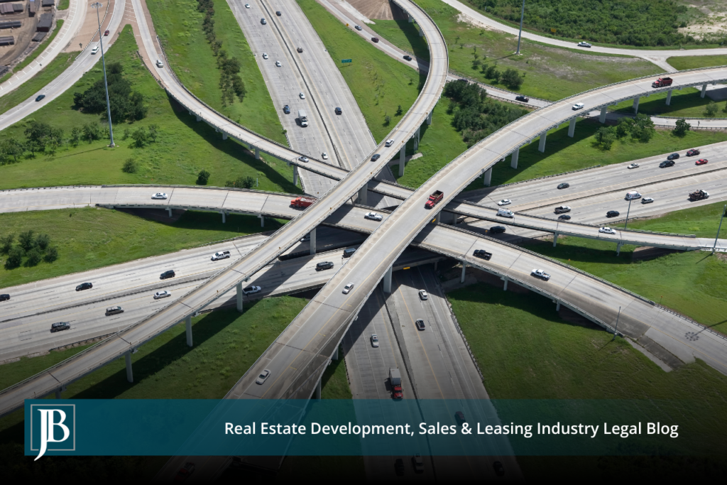 Aerial view of a multi-level highway interchange with flyover ramps and merging traffic, illustrating the type of reconstruction underway at Tampa's Westshore Interchange (I-275/SR 60).