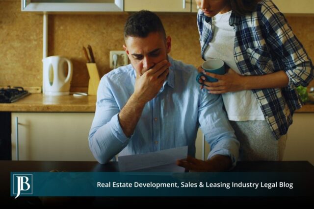 A worried man in a blue shirt reads a legal notice at his kitchen table while a woman holding a coffee mug stands beside him, below a Jimerson Birr banner reading "Real Estate Development, Sales & Leasing Industry Legal Blog."