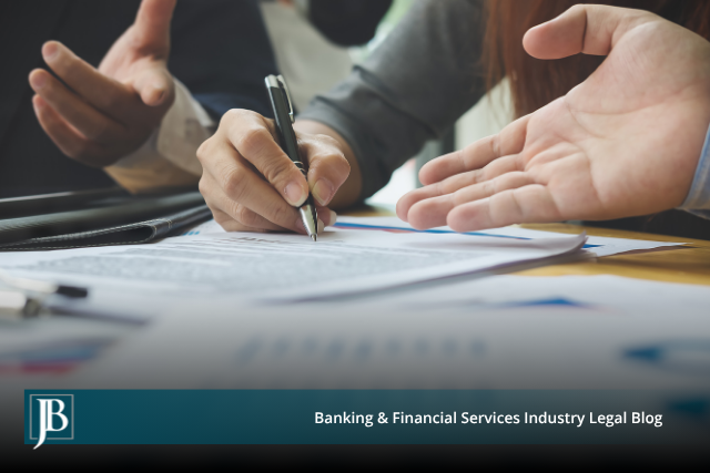 Two business professionals reviewing and signing a financial contract at a desk with charts, illustrating offsets and credits in Florida collection lawsuit defense.