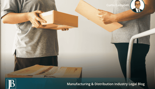 Two warehouse workers handing cardboard boxes across a receiving area, illustrating the delivery date that controls a 503(b)(9) claim.