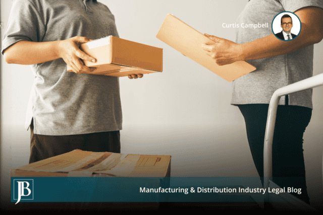 Two warehouse workers handing cardboard boxes across a receiving area, illustrating the delivery date that controls a 503(b)(9) claim.