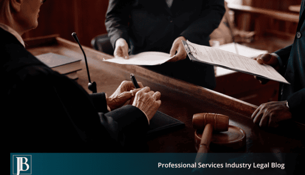 A Florida judge at the bench reviews documents handed up by business litigation attorneys during a commercial court hearing, with a gavel resting on the bench.
