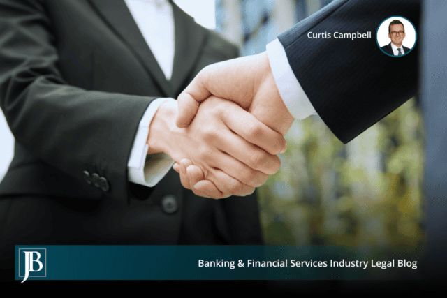 Two business professionals shaking hands outside an office building, a handoff of a business that can raise successor liability.