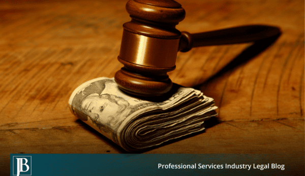 Wooden gavel resting on a folded stack of cash on a wood table, illustrating damages for tortious interference in Florida business litigation.