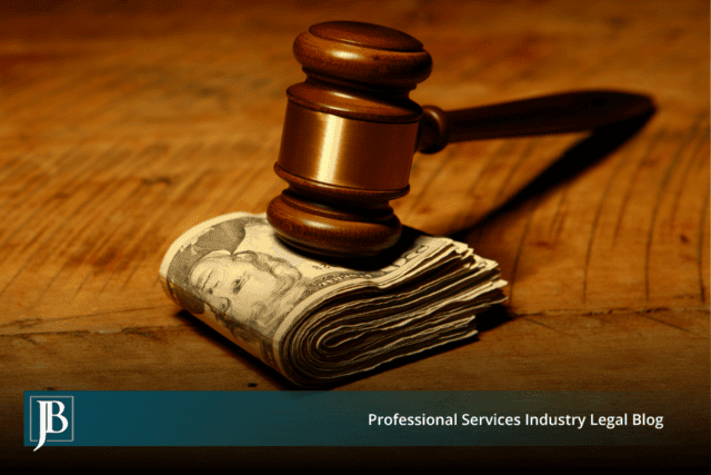 Wooden gavel resting on a folded stack of cash on a wood table, illustrating damages for tortious interference in Florida business litigation.