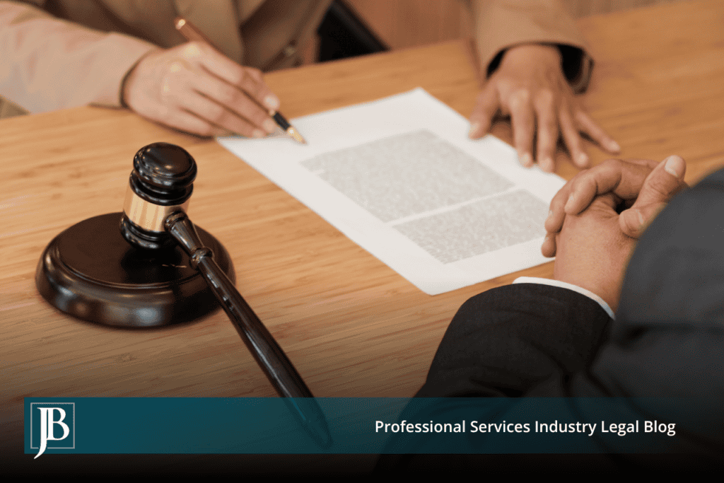 Attorney and business client reviewing a temporary injunction motion at a conference table next to a wooden gavel.