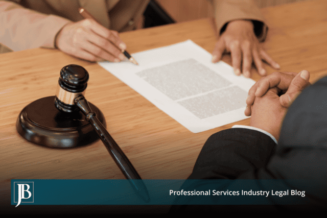 Attorney and business client reviewing a temporary injunction motion at a conference table next to a wooden gavel.