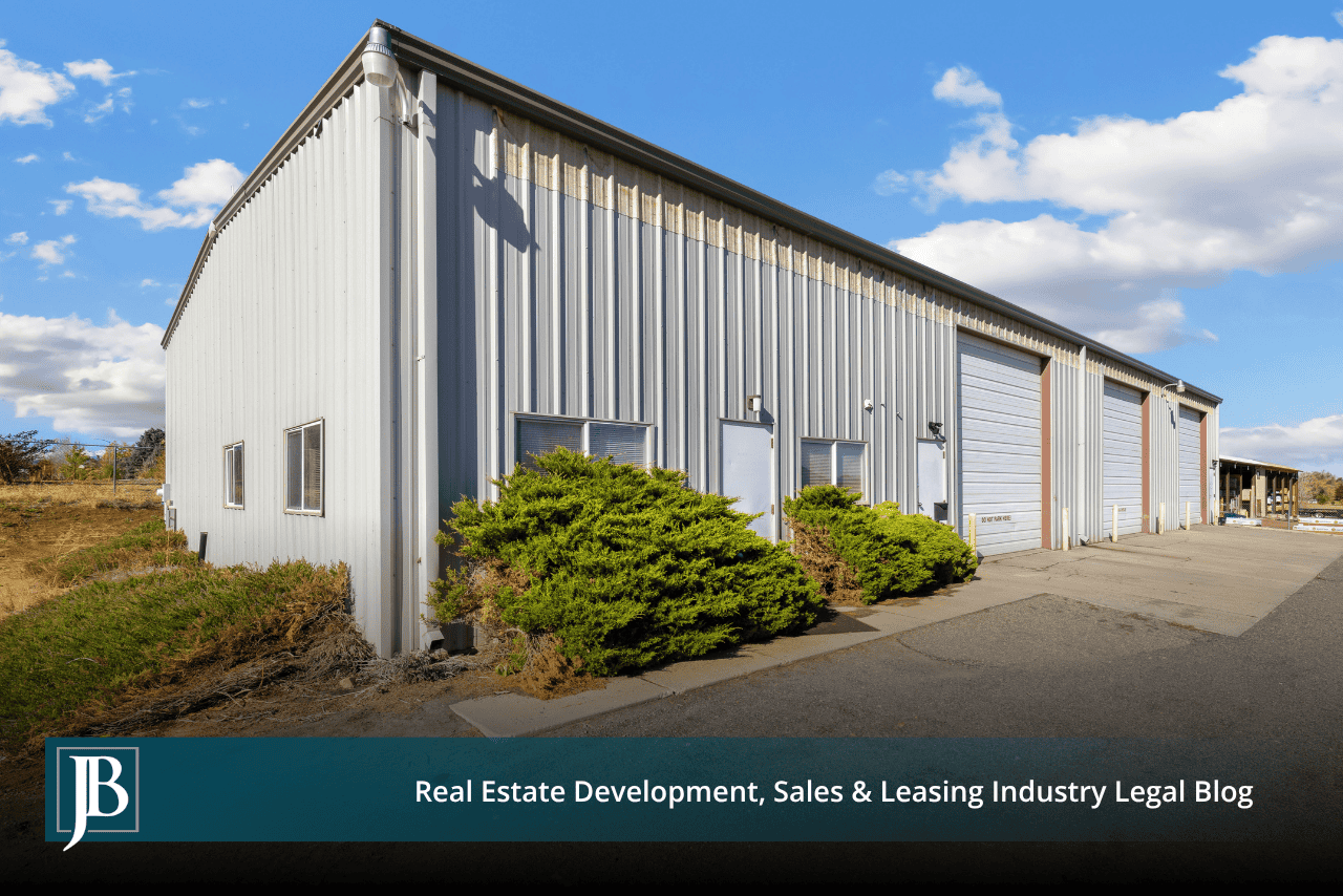 Metal warehouse with roll-up bay doors and a paved truck apron, illustrating what an FDOT eminent domain appraisal can miss