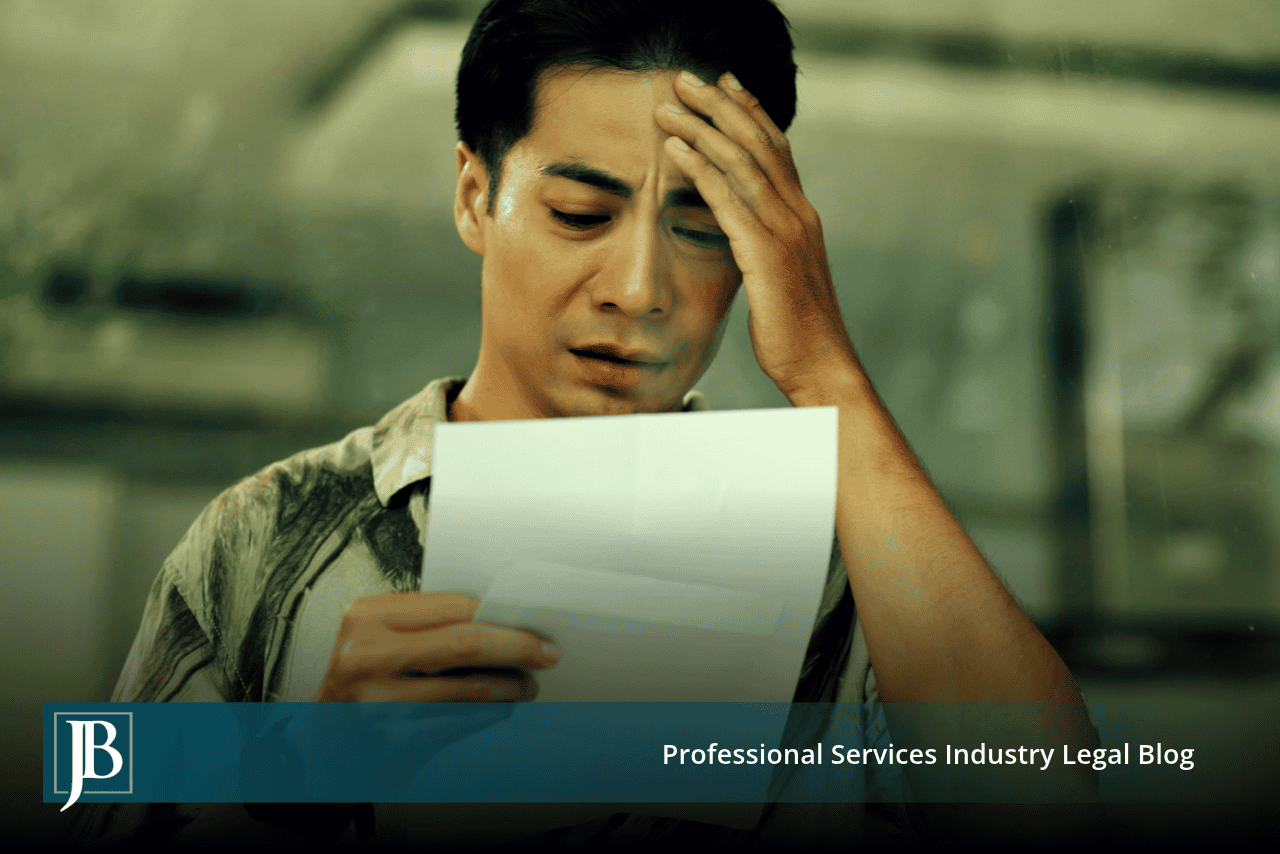 Worried man reading a letter with his hand on his forehead, illustrating what to do after a demand letter arrives