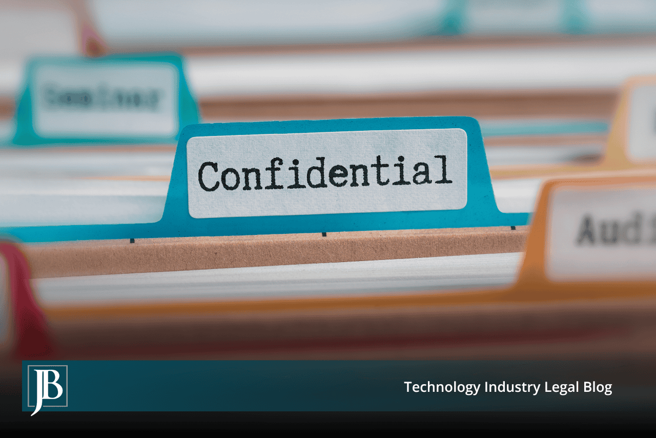 File folder tab labeled Confidential in a filing drawer, illustrating how to protect trade secrets before an employee leaves