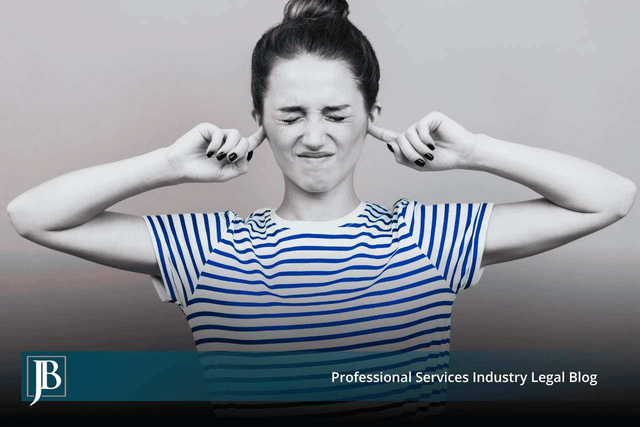 Woman with her fingers in her ears and eyes squeezed shut, illustrating a business that ignored a lawsuit