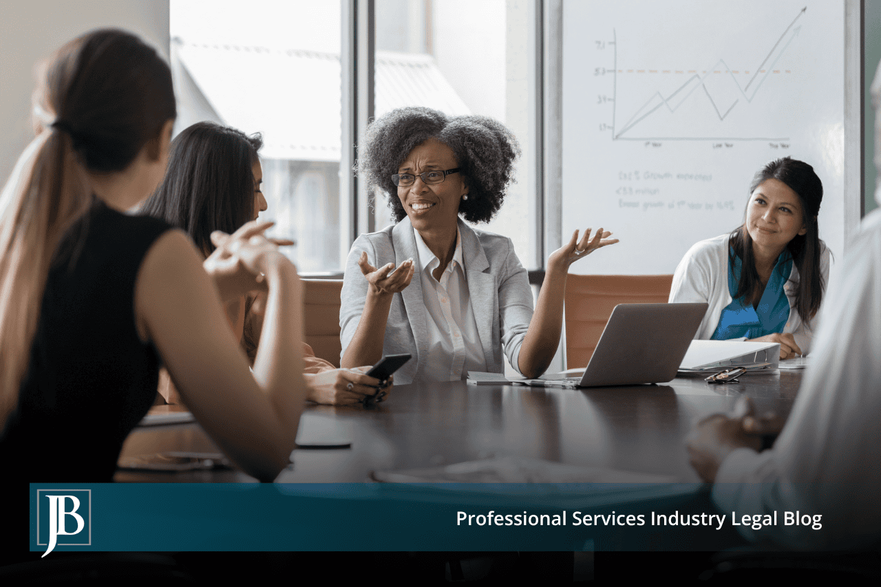 Business owner gesturing as she explains a point at a conference table, illustrating when an LLC manager owes fiduciary duties